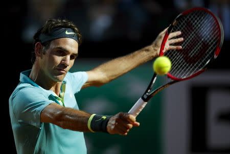 Roger Federer of Switzerland returns the ball to Pablo Cuevas of Uruguay during their tennis match at the Rome Open tennis tournament in Rome, Italy, May 13, 2015. REUTERS/Max Rossi