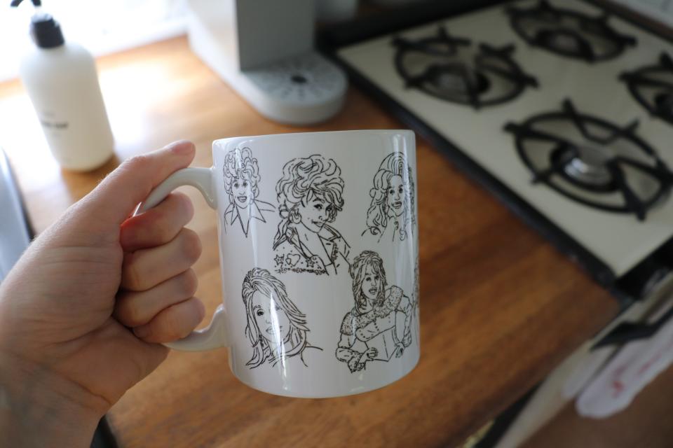 A mug with Dolly Parton cartoons on it