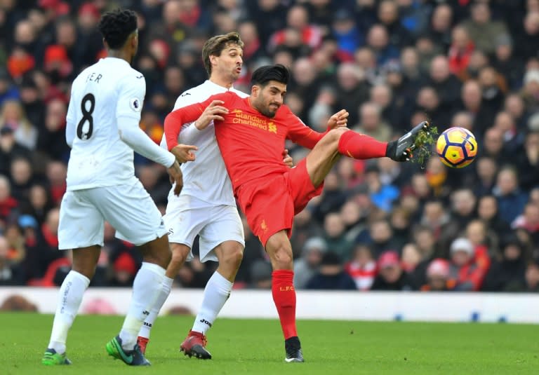 Liverpool's German midfielder Emre Can (R) is challenged by Swansea's Spanish striker Fernando Llorente (C) during the English Premier League match at Anfield in Liverpool, north-west England on January 21, 2017