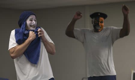 Inmates David Di Marino (L) and Tarifa Henson participate in the workshop "Commedia Dell'Arte", part of the The Actors' Gang Prison Project program at the California Rehabilitation Center in Norco, California in this September 30, 2014 file photo. REUTERS/Mario Anzuoni/Files