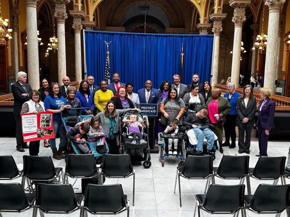 Members of the Indiana Families United for Care pose with Indiana democrats after meeting to discuss their concerns with the proposed shifts for Medicaid caregivers.