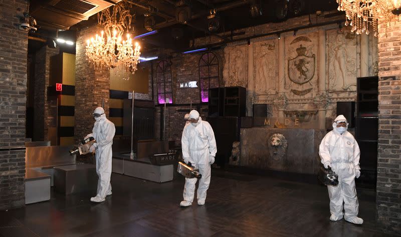 Quarantine worker spray disinfectants at a night club on the night spots in the Itaewon neighborhood, following the coronavirus disease (COVID-19) outbreak, in Seoul