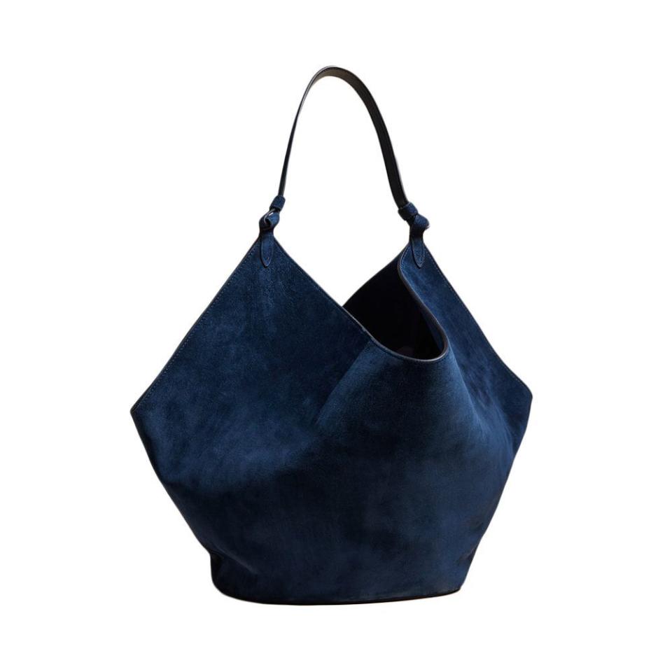 <p><a href="https://go.redirectingat.com?id=74968X1596630&url=https%3A%2F%2Fwww.matchesfashion.com%2Fus%2Fproducts%2FKhaite-Lotus-medium-suede-tote-bag-1559490&sref=https%3A%2F%2F" rel="nofollow noopener" target="_blank" data-ylk="slk:Shop Now;elm:context_link;itc:0;sec:content-canvas" class="link ">Shop Now</a></p><p>Lotus Medium Suede Tote Bag</p><p>$2900.00</p>