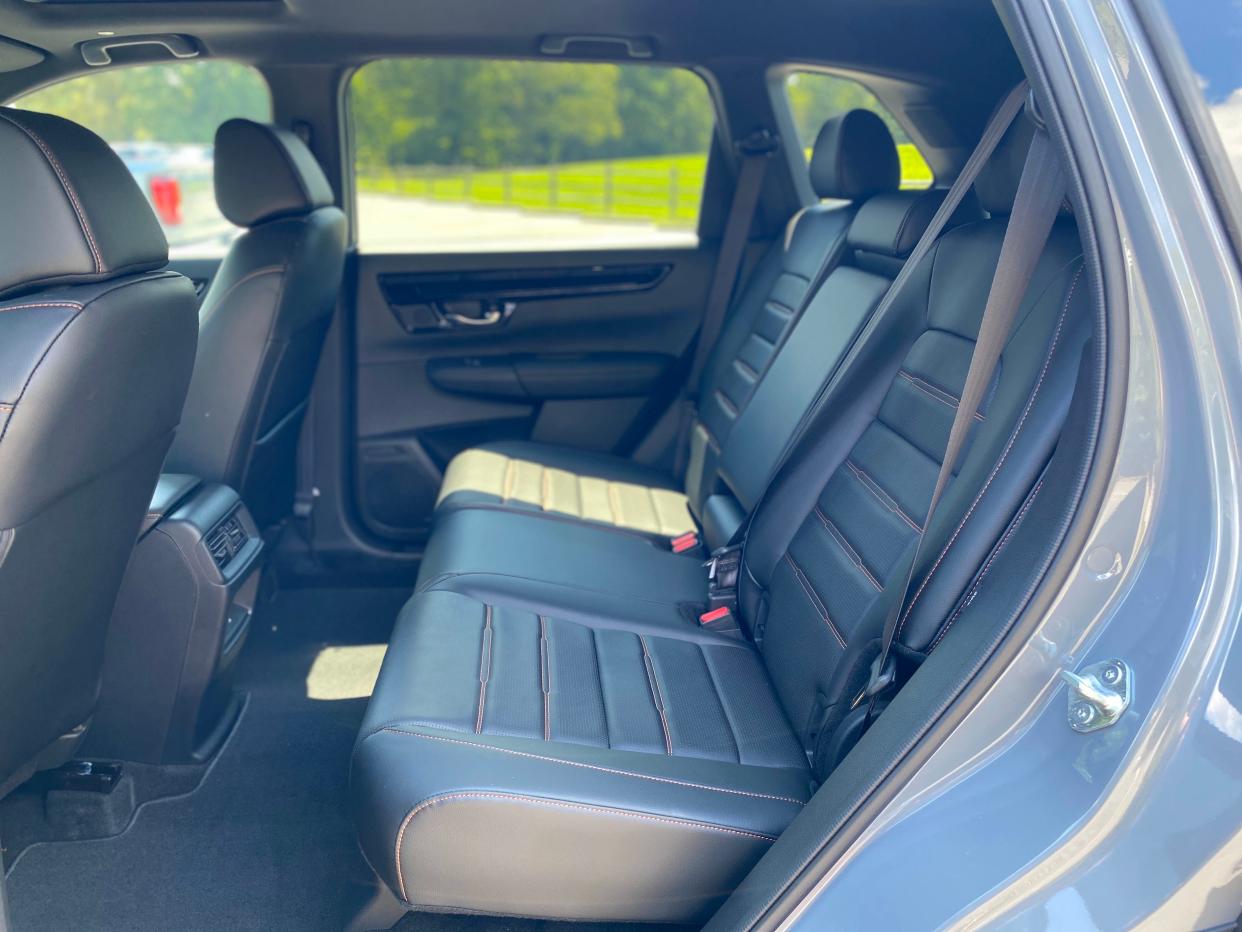 The black leather back seats with red stitching in a gray 2025 Honda CR-V Hybrid Sport Touring SUV.