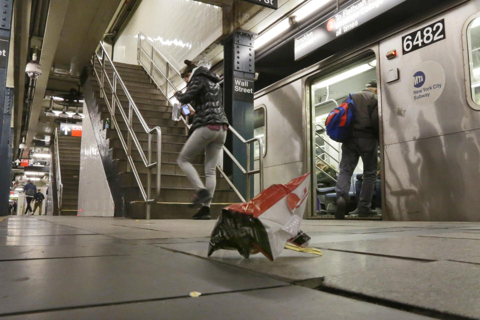 A empty snack food bag litters the Wall Street subway platform, in New York, Thursday, March 30, 2017. Faced with the problem of too much litter and too many rats in their subway stations, New York City transit officials began an unusual social experiment a few years ago. They removed trash bins entirely from select stations, figuring it would deter people from bringing garbage into the subway in the first place. This week, they pulled the plug on the program after reluctantly concluding that it was a failure. (AP Photo/Richard Drew)