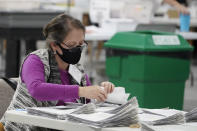 Officials work on ballots at the Gwinnett County Voter Registration and Elections Headquarters, Friday, Nov. 6, 2020, in Lawrenceville, near Atlanta. (AP Photo/John Bazemore)