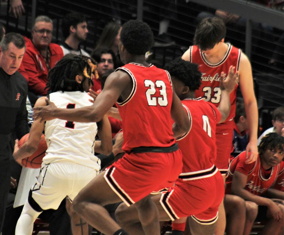 Fairfield's Mason King (23) and Elijah Bembry (0) surround Wayne senior Lawrent Rice, one of the top players in the state, during Fairfield's 76-51 win over Huber Heights Wayne in an OHSAA Division I boys basketball district championship game March 4, 2023, at University of Dayton Arena.