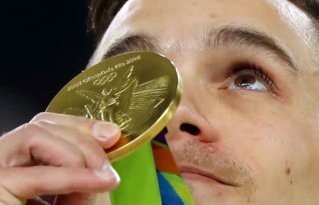 2016 Rio Olympics - Artistic Gymnastics - Victory Ceremony - Men's Rings Victory Ceremony - Rio Olympic Arena - Rio de Janeiro, Brazil - 15/08/2016. Eleftherios Petrounias (GRE) of Greece receives his gold medal. REUTERS/Mike Blake