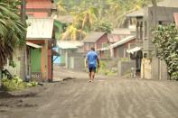 A man walks down a street after a series of eruptions from La Soufriere volcano