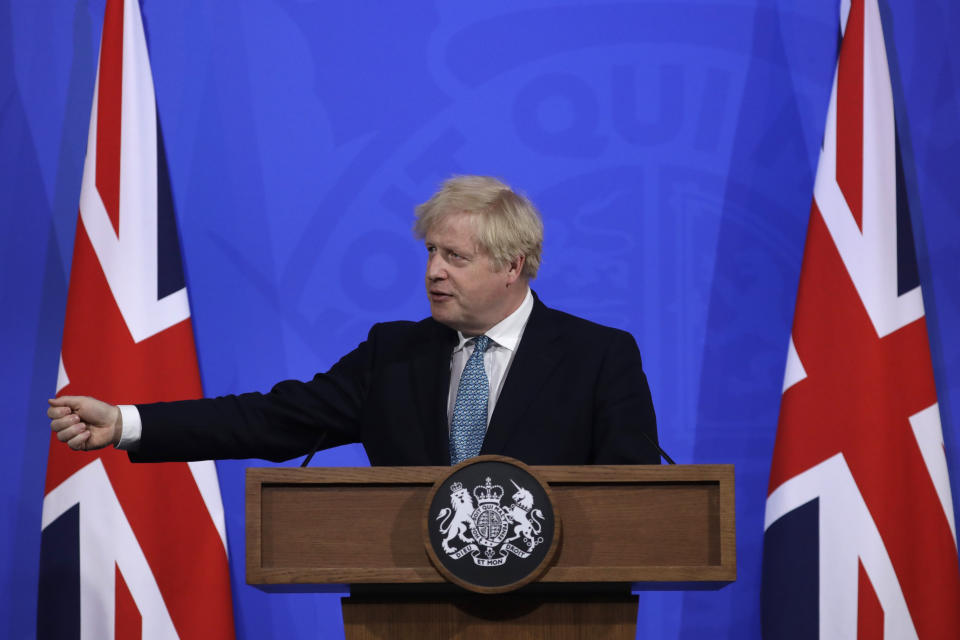 Britain's Prime Minister Boris Johnson gestures as he answers a question from the media at a press conference about the ongoing coronavirus outbreak, in London, Friday, May 14, 2021. (AP Photo/Matt Dunham, Pool)