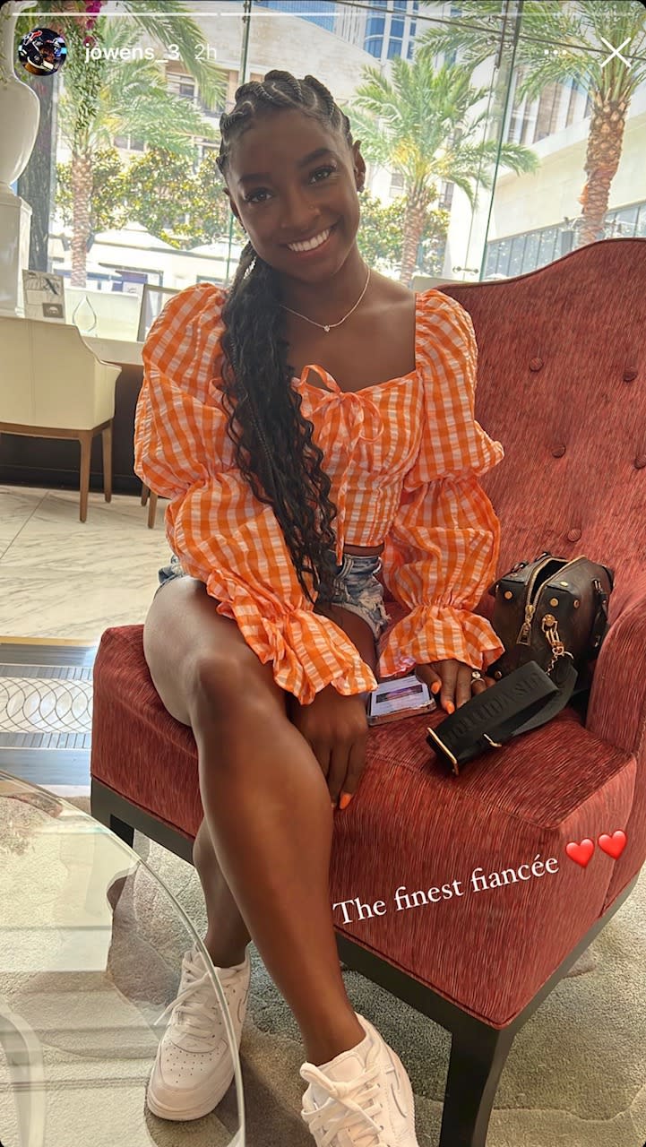 Simone Biles wearing a gingham printed shirt with cutoff denim shorts and a pair of Nike Air Force 1s. - Credit: Instagram