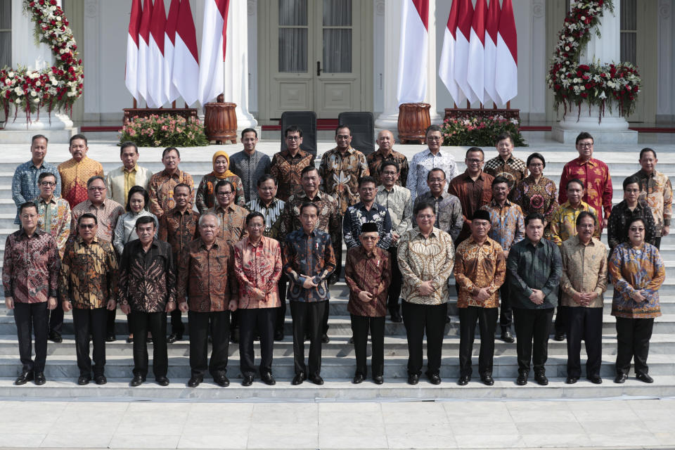 Indonesian President Joko Widodo, front row sixth from left, and his deputy Ma'ruf Amin, seventh from left, pose for photographers during the announcement of the new cabinet at Merdeka Palace in Jakarta, Indonesia, Wednesday, Oct. 23, 2019. (AP Photo/Dita Alangkara)