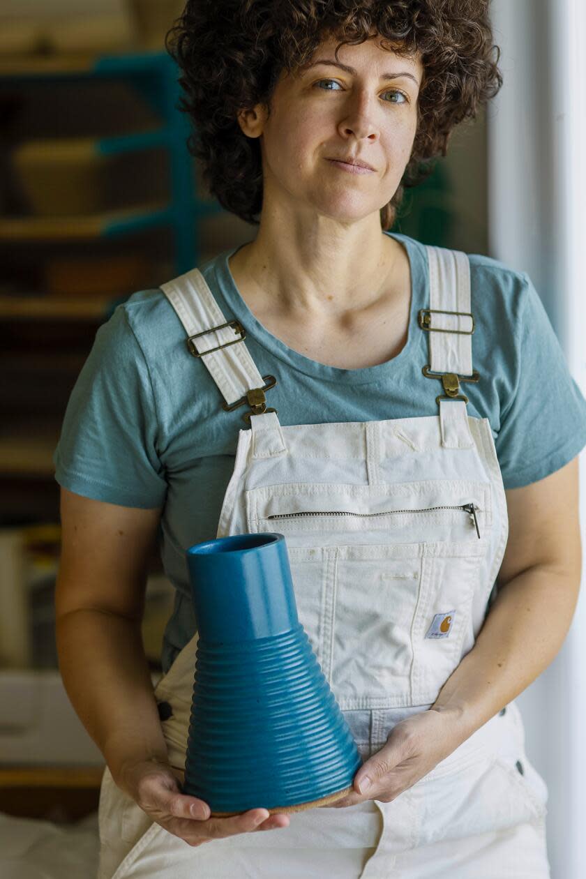 Becki Chernoff holds a ceramic vase