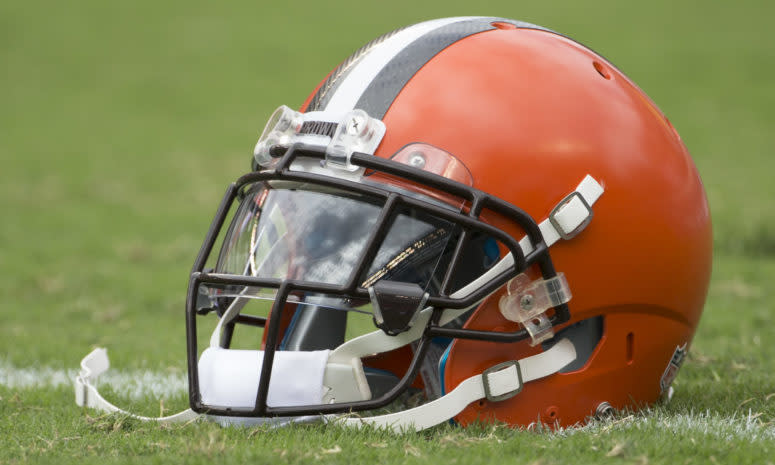 A Cleveland Browns helmet sitting on the field.