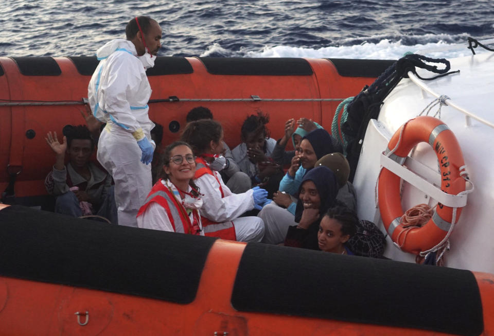 Migrants are evacuated by Italian Coast guards from the Open Arms Spanish humanitarian boat off the coast of the Sicilian island of Lampedusa, southern Italy, Thursday, Aug.15, 2019. the Spanish aid boat with 147 rescued migrants aboard is anchored off a southern Italian island as Italy's ministers spar over their fate. (AP Photo/Francisco Gentico)