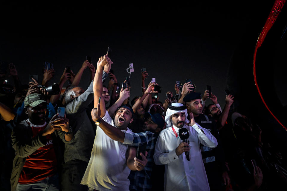 Fans celebrate the final countdown next to the 2022 World Cup countdown clock before the start of the World Cup opening match between Qatar and Ecuador at the Doha's Corniche promenade, in Doha, on Nov. 20.<span class="copyright">Patricia De Melo Moreira—AFP/Getty Images</span>