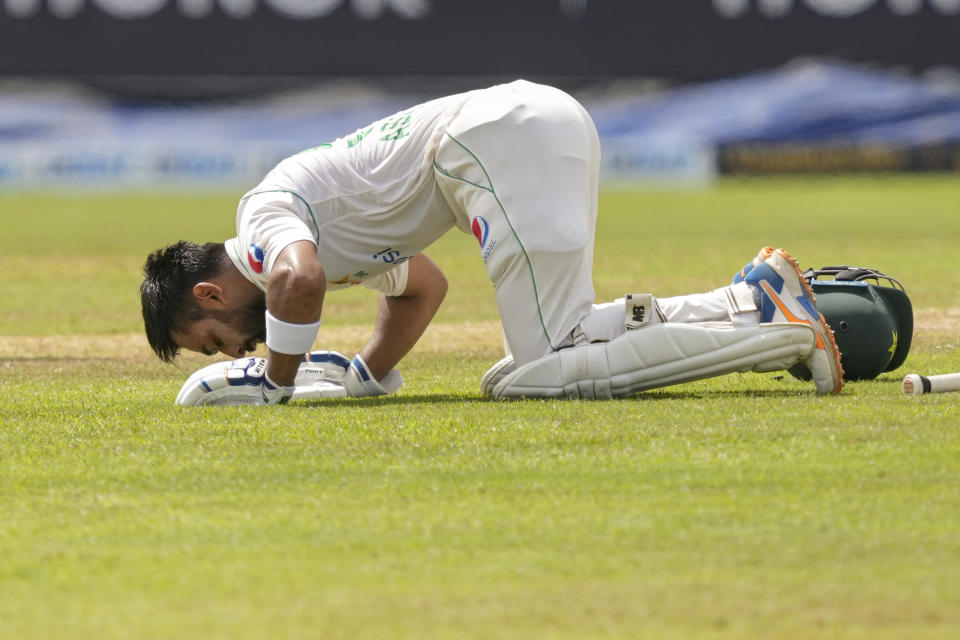 Pakistan's Abdullah Shafique kisses the pitch after scoring a century during the third day of the second cricket test match between Sri Lanka and Pakistan in Colombo, Sri Lanka on Wednesday, Jul. 26. (AP Photo/Eranga Jayawardena)