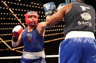 <p>Mark “Muscle Shark” Sinatra extends a punch against Erin Fitchette in the Super Heavy Champ class of the NYPD Boxing Championships at the Theater at Madison Square Garden on June 8, 2017.(Photo: Gordon Donovan/Yahoo News) </p>