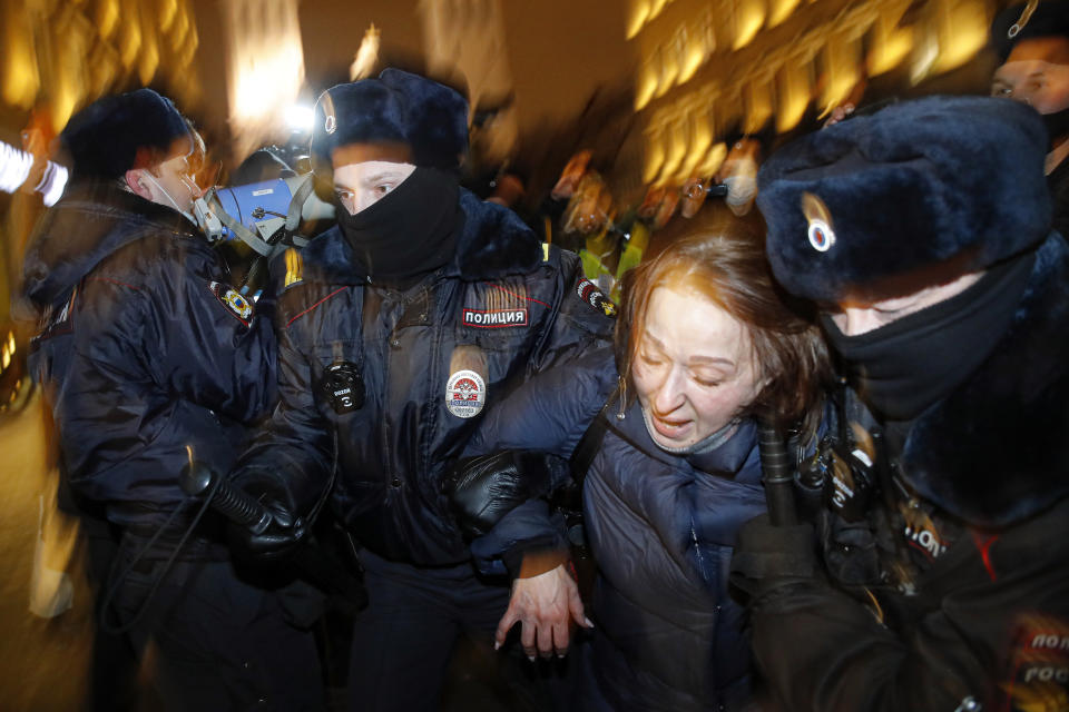 Police officers detain a Navalny supporter during a protest in St. Petersburg, Russia, Tuesday, Feb. 2, 2021. A Moscow court has ordered Russian opposition leader Alexei Navalny to prison for more than 2 1/2 years on charges that he violated the terms of his probation while he was recuperating in Germany from nerve-agent poisoning. Navalny, who is the most prominent critic of President Vladimir Putin, had earlier denounced the proceedings as a vain attempt by the Kremlin to scare millions of Russians into submission. (AP Photo/Dmitri Lovetsky)