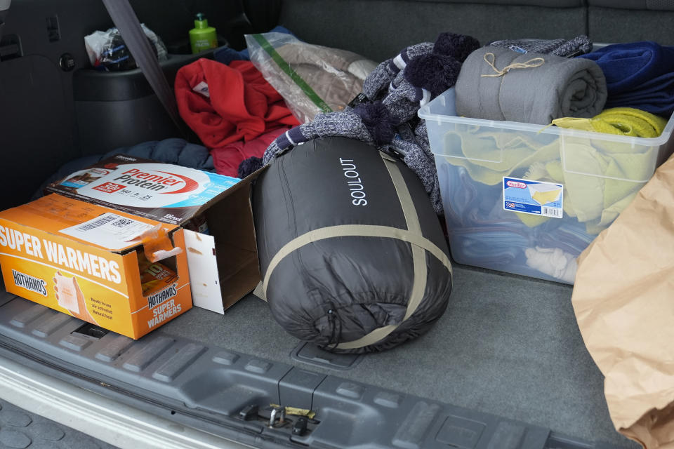 Blankets and warming supplies are seen in in the back of a vehicle Thursday, Jan. 18, 2024, in Nashville, Tenn. A resource specialist for the homeless outreach organization Open Table Nashville has been canvassing the area delivering the items to people living outside. A snowstorm blanketed the region with up to eight inches of snow and frigid temperatures. (AP Photo/George Walker IV)