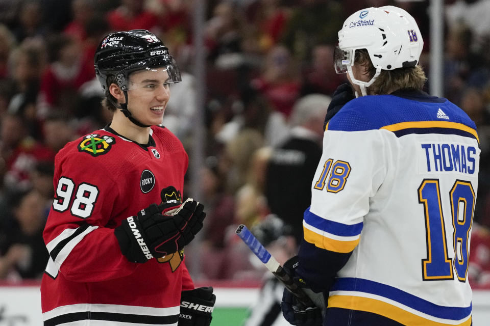 Chicago Blackhawks center Connor Bedard, left, talks with St. Louis Blues center Robert Thomas before a faceoff during the second period of a preseason NHL hockey game Thursday, Sept. 28, 2023, in Chicago. (AP Photo/Erin Hooley)