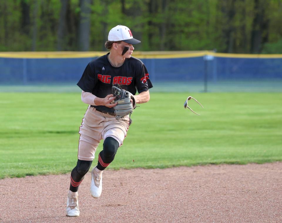 Milan shortstop Jaxon Morawski loses his sunglasses as he prepares to throw to first base against Whiteford Friday night.