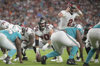 Tampa Bay Buccaneers offensive tackle Robert Hainsey (70) gets ready to snap the ball to quarterback Kyle Trask (2) against the Miami Dolphins during the first half of an NFL preseason football game Saturday, Aug. 13, 2022, in Tampa, Fla. (AP Photo/)