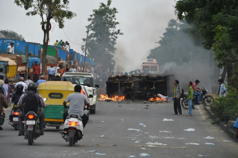 Some 15,000 police officers have been deployed to the streets of Bangalore to enforce a curfew after rampaging, stone-pelting mobs set buses and cars ablaze on September 12, 2016
