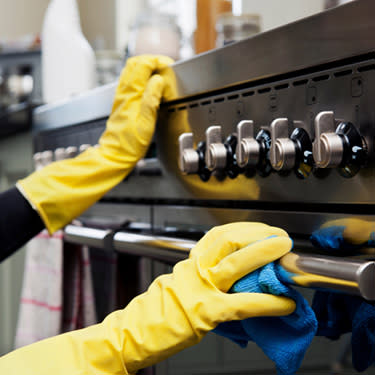 Woman-cleaning-oven-in-kitchen_web