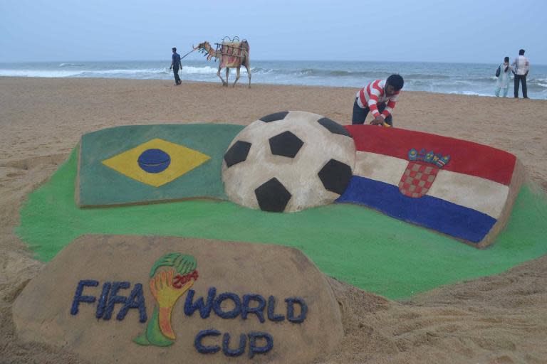 A sand sculpture celebrating the World Cup opener between Brazil and Croatia, by sand artist Sudarsan Pattnaikat at Puri beach in India