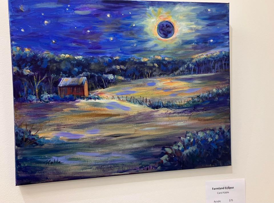 Carol Kable's interpretation of the eclipse on the farmland in part of the new exhibit at Crawford County Art Center.