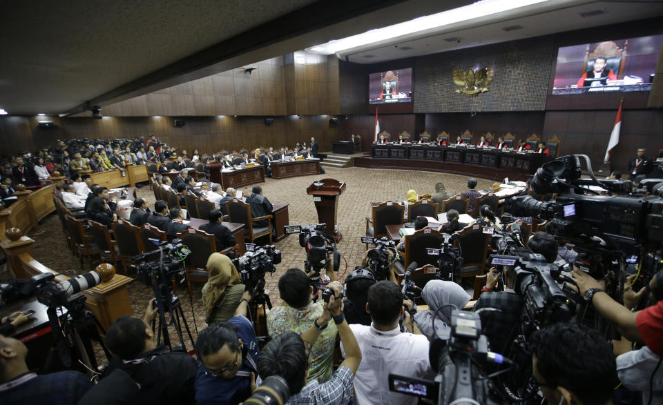 Judges preside over the first hearing of a challenge to the results of April's presidential election at the Constitutional Court in Jakarta, Indonesia, Friday, June 14, 2019. The losing candidate former Gen. Prabowo Subianto claims there was massive electoral fraud and is asking the Constitutional Court to invalidate the election. The court is expected to rule by June 28. (AP Photo/Achmad Ibrahim)