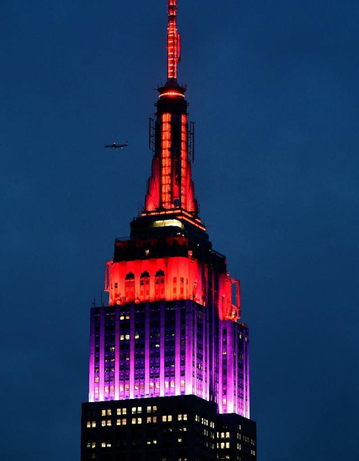The Empire State Building is lit in red and purple in New York on April 14, 2015, in honor of more than 200 Nigerian girls kidnapped by Boko Haram militants one year ago (AFP Photo/Timothy A. Clary)