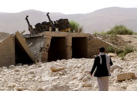 A man inspects damage of an airstrike on a truck in the northwestern city of Saada, Yemen June 21, 2018. REUTERS/Naif Rahma