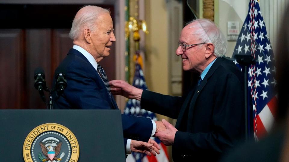 PHOTO: President Joe Biden stands with Sen. Bernie Sanders, I-Vt., after speaking about lowering health care costs in the Indian Treaty Room at the Eisenhower Executive Office Building on the White House complex in Washington, April 3, 2024.  (Mark Schiefelbein/AP)