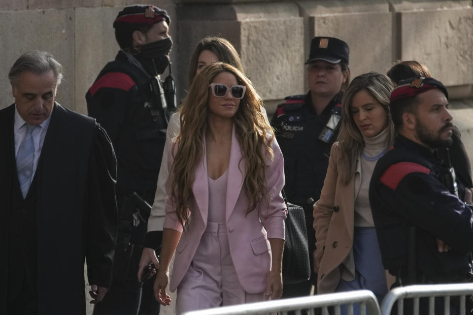 Colombian performer Shakira, center, arrives at court in Barcelona, Spain, Monday, Nov. 20, 2023. Global pop star Shakira is summoned on Monday to a Barcelona courthouse for the opening day of her trial for allegedly defrauding Spanish tax officials of millions of euros. Shakira faces six counts of failing to pay the Spanish government 14.5 million euros (now $15.8 million) in taxes between 2012 and 2014. (AP Photo/Emilio Morenatti)