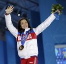 Women's free skate figure skating gold medalist Adelina Sotnikova of Russia waves during the medals ceremony at the 2014 Winter Olympics, Friday, Feb. 21, 2014, in Sochi, Russia. (AP Photo/David Goldman)