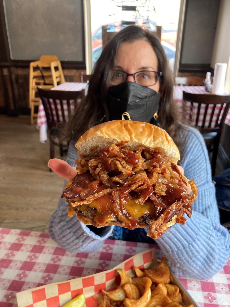 Lohud Food & Dining Reporter Jeanne Muchnick with the Bobby-O burger from Brookside Tavern in Valley Cottage.    Photographed Jan. 21, 2022.