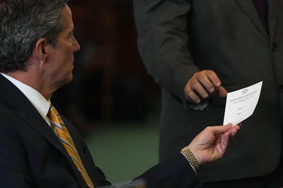 Senator Kelly Hancock hands in a vote during the impeachment trial of Attorney General Ken Paxton at the Texas Capitol on Saturday, Sep. 16, 2023.
