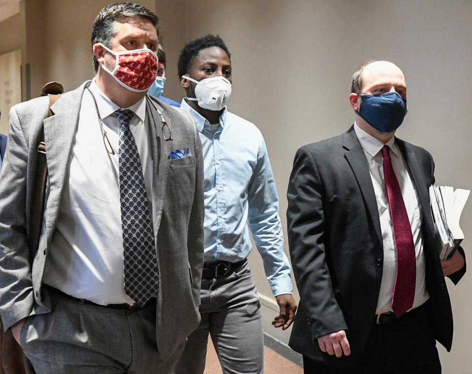 Tory Johnson, center, a suspect in the Bama Lanes shooting, arrives with lawyers for his bail hearing at the Montgomery County Courthouse in Montgomery, Ala., on Thursday January 13, 2022. 