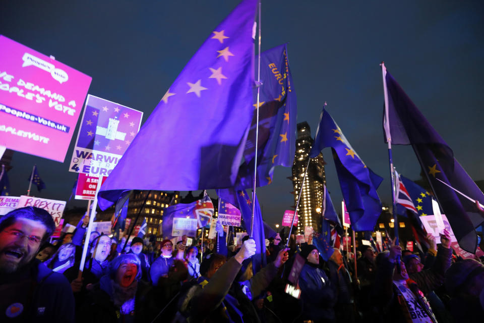 Pro-European demonstrators hold EU flags at Parliament Square in London, Tuesday, Jan. 15, 2019. Britain's Prime Minister Theresa May is struggling to win support for her Brexit deal in Parliament. Lawmakers are due to vote on the agreement Tuesday, and all signs suggest they will reject it, adding uncertainty to Brexit less than three months before Britain is due to leave the EU on March 29. (AP Photo/Frank Augstein)