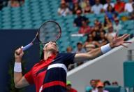 Mar 31, 2019; Miami Gardens, FL, USA; John Isner of the United States serves to Roger Federer of Switzerland during the men's finals at Miami Open Tennis Complex. Steve Mitchell-USA TODAY Sports