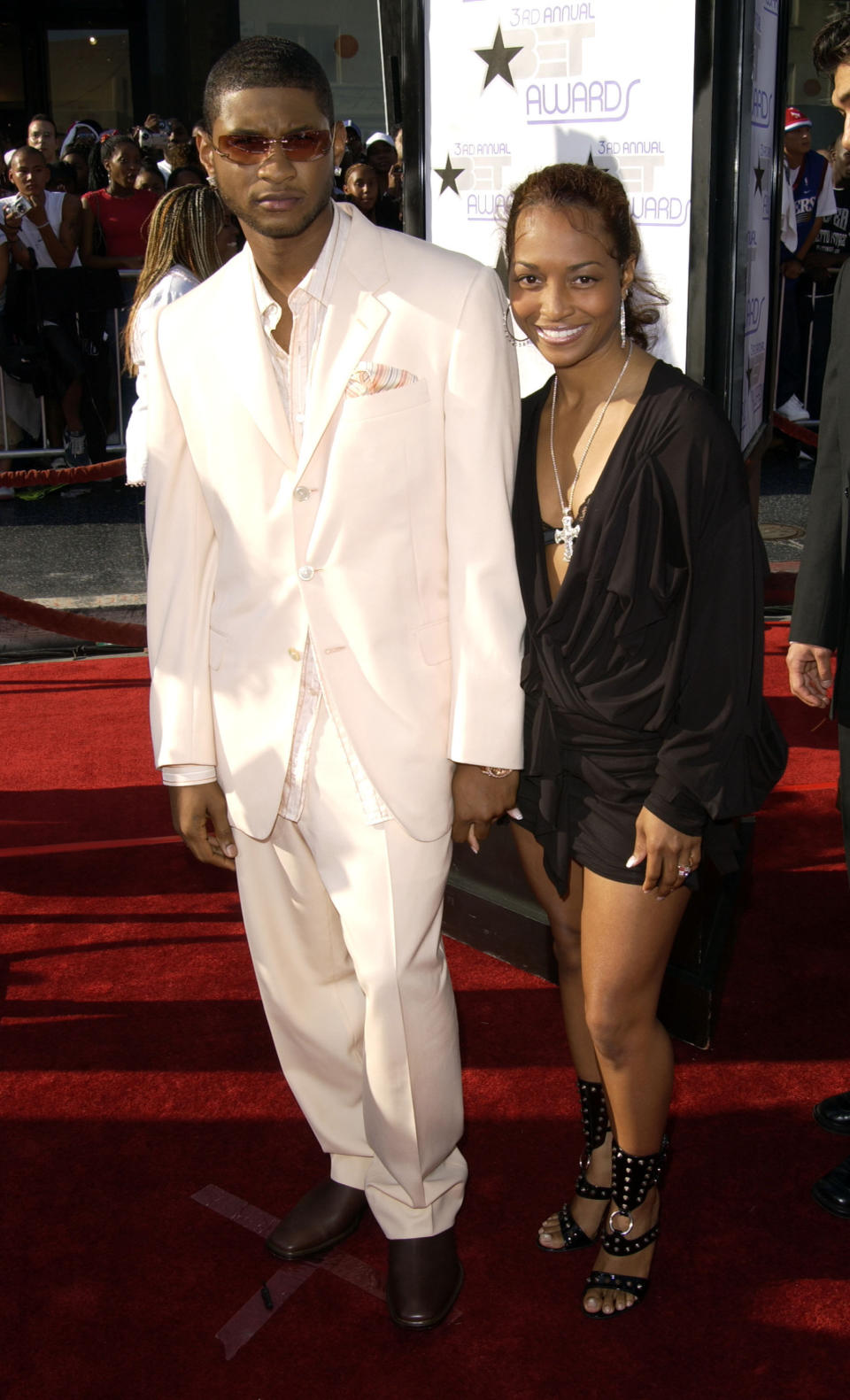 The former couple holding hands as they walk the red carpet at an event