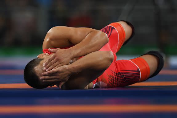 RIO DE JANEIRO, BRAZIL - AUGUST 21:  Mandakhnaran Ganzorig (red) of Mongolia reacts following his defeat to Ikhtiyor Navruzov (blue) of Uzbekistan in the Men's Freestyle 65kg Bronze match against  on Day 16 of the Rio 2016 Olympic Games at Carioca Arena 2 on August 21, 2016 in Rio de Janeiro, Brazil.  (Photo by Laurence Griffiths/Getty Images)