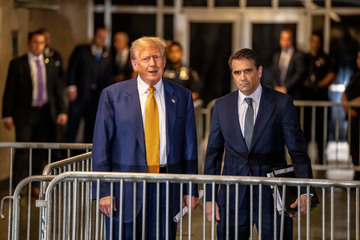 Former president Donald Trump leaves court alongside his lawyer Todd Blanche (Mark Peterson/Redux Pictures)