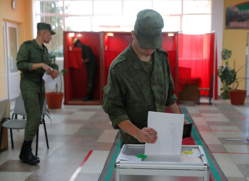 A Belarusian?serviceman casts his ballot at a polling station during the presidential election in Minsk