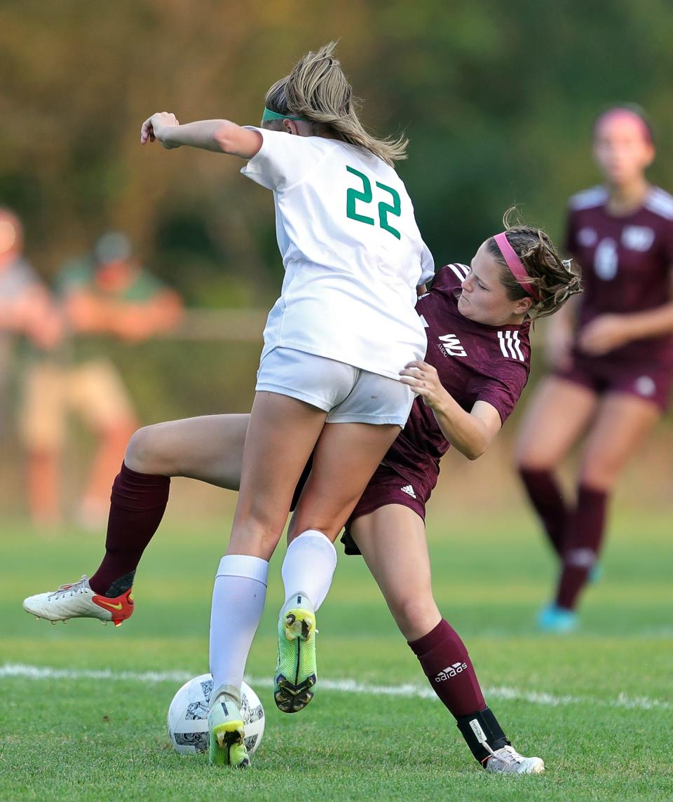 Walsh Jesuit's Lexi Pascarella, right, collides with Strongsville's Gabby Keefe during the first half of a soccer game, Wednesday, Aug. 24, 2022, in Cuyahoga Falls, Ohio.