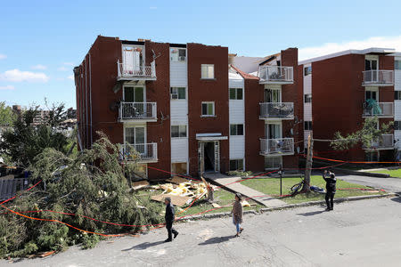 People look at damaged buildings after a tornado hit the Mont-Bleu neighbourhood in Gatineau, Quebec, Canada, September 22, 2018. REUTERS/Chris Wattie