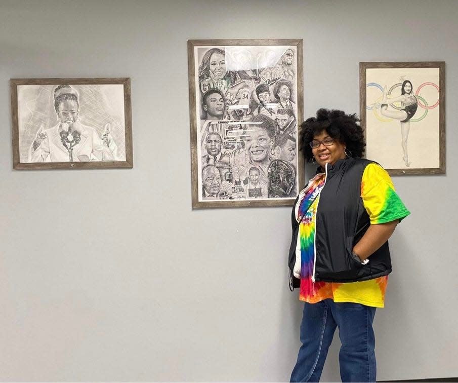 Canton native and McKinley High School graduate Deseré Mayo is shown with artwork she created. Mayo's work is featured in her solo exhibition at Malone University, "Black Lives Belong: Power Through the Decades."