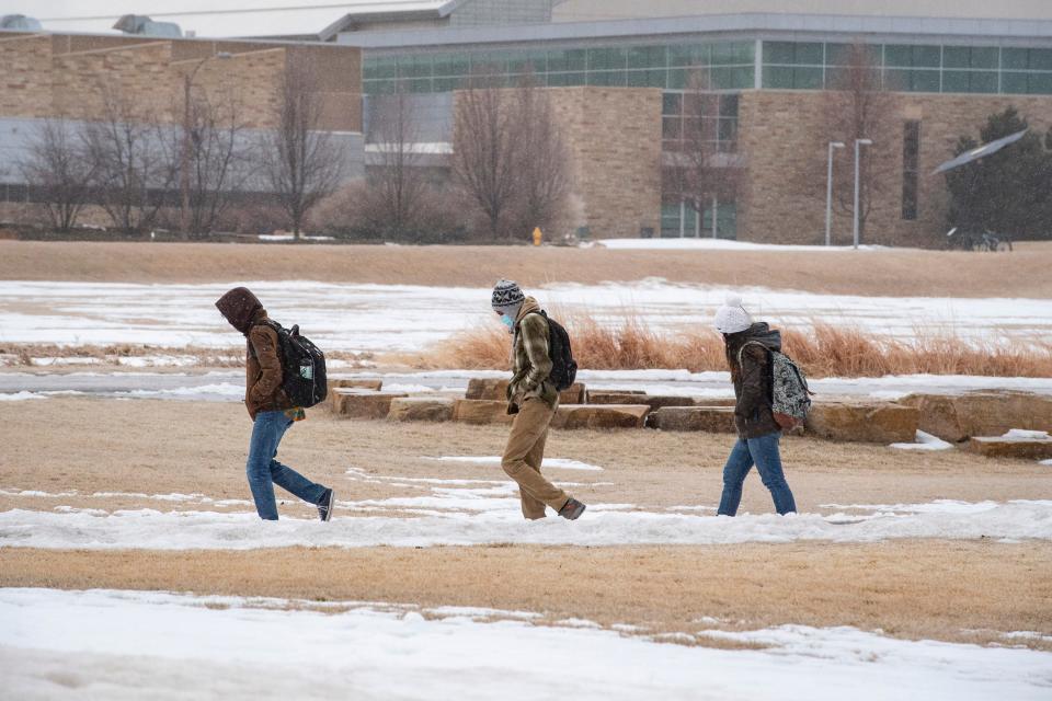 Colorado State University students walk along a pedestrian path at CSU on Wednesday, Jan. 19, 2022.